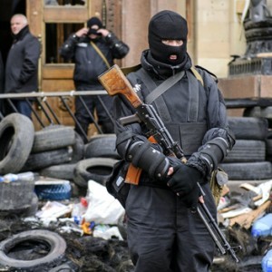 An armed man, representing Ukrainian special forces, stands guard outside the regional administration building in Kharkiv